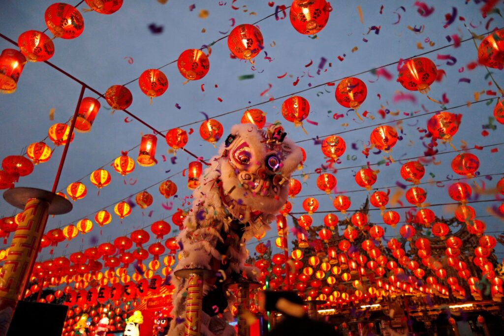Chinese New Year lion dance under red lanterns